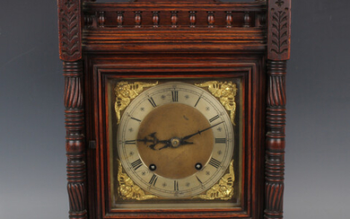 A late 19th century Arts and Crafts style oak mantel clock with eight day movement striking on two g