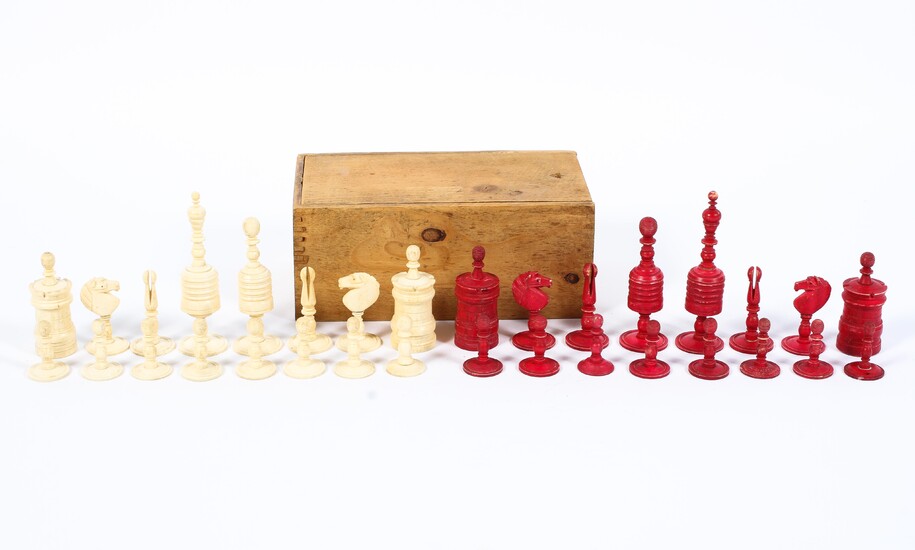 A late 19th/early 20th century carved and red-stained bone chess set