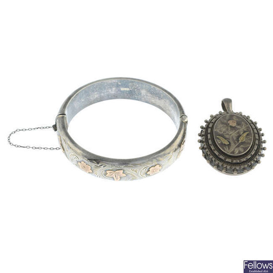A late Victorian silver floral locket and a mid 20th century silver floral bangle.