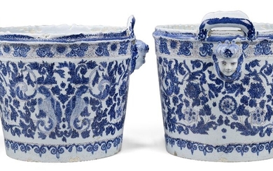 A pair of Continental faïence two-handled jardinières, probably c.1900, blue N marks, of bucket-shaped form, each with masks below lug handles, painted in dark-blue and manganese with fantastic birds gripping foliate scrolls in their beaks, issuing...