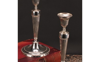 A pair of George III Neo-Classical silver table candlesticks...