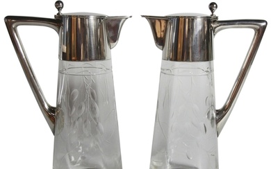 A pair of glass wine decanters with silver handles and lid -...