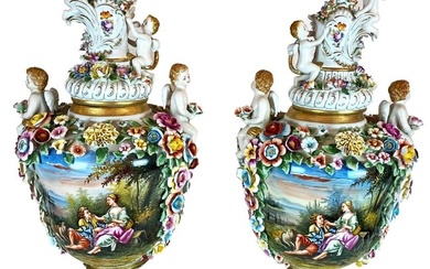 A pair of hand-painted porcelain vases embellished with cherubs