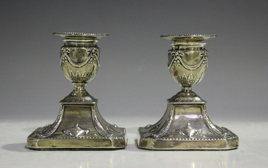 A pair of late Victorian silver stub candlesticks, each with a beaded detachable nozzle above an ovo