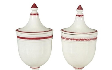 A pair of painted creamware covered urns, 18th/19th