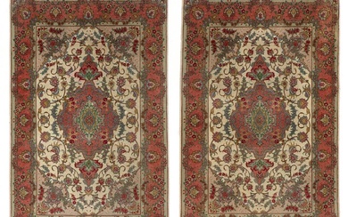 A pair of signed Tabriz rugs, Persia. Outlines and minor part with...