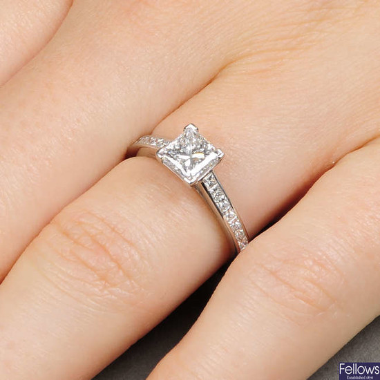 A platinum square-shape diamond single-stone ring, with