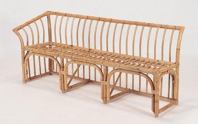 A rare asymmetric rattan bench C 1950. Ht: 30" Wd: 70.75" Dpth: 21" Seat: 17"