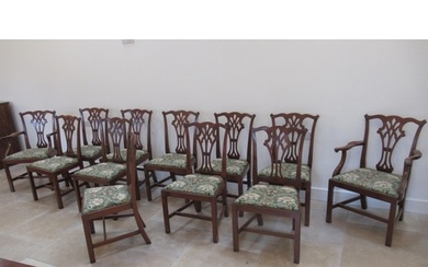 A set of 12 Georgian style mahogany dining chairs to include...