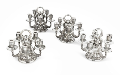 A set of four five-light silver candlesticks, Georg Jensen, Copenhagen, modern | Ensemble de quatre chandeliers à cinq lumières en argent par Georg Jensen, Copenhague, moderne