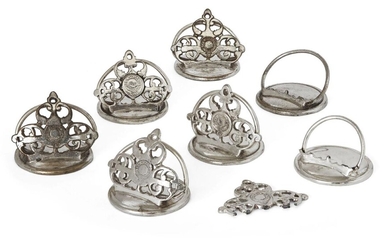 A set of seven silver plated menu holders,19th century, each pierced trefoil section decorated with the Athenaeum Club crest, two holders damaged, bases weighted (7) Note: The Athenæum is a private Members' Club in London established in 1824 to...