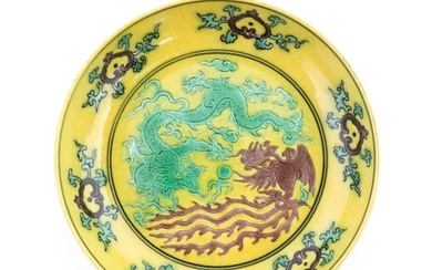 A small Chinese dish with a yellow ground decorated with a d...