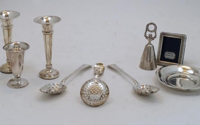 A small group of silver, comprising: two George IV spoons, London, 1823, maker CH, later repousse decorated with berries to bowls, 17.4cm long; two posy vases, Birmingham, 1973, Toye, Kenning & Spencer, on filled circular bases, 11.7cm high; a...