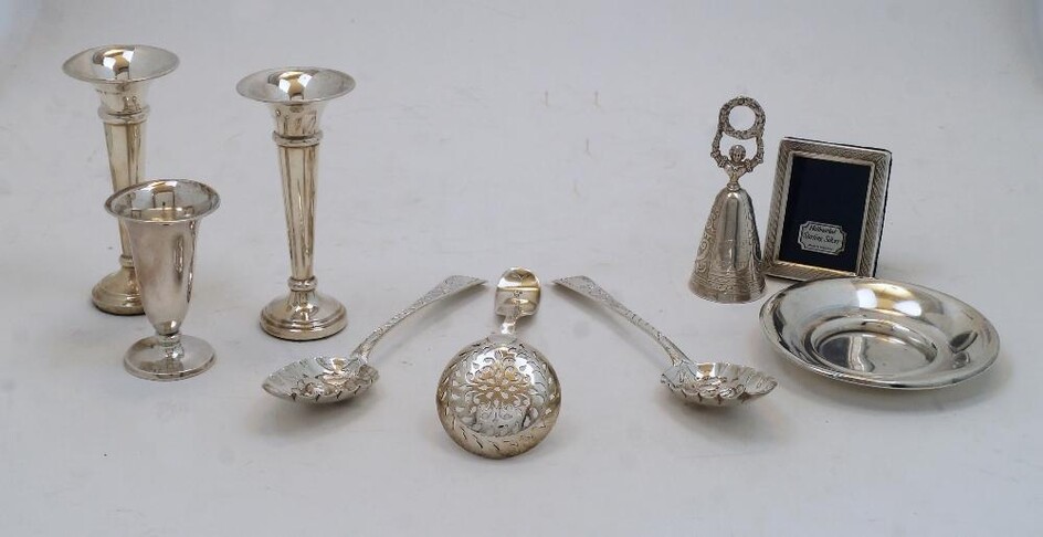 A small group of silver, comprising: two George IV spoons, London, 1823, maker CH, later repousse decorated with berries to bowls, 17.4cm long; two posy vases, Birmingham, 1973, Toye, Kenning & Spencer, on filled circular bases, 11.7cm high; a...