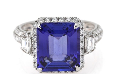 A tanzanite and diamond ring set with an emerald-cut tanzanite weighing app....