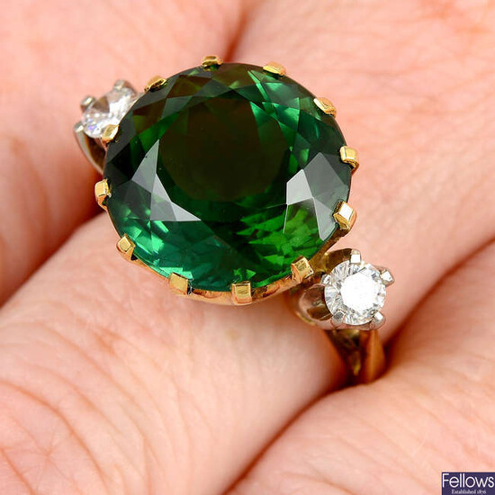 A green tourmaline and brilliant-cut diamond ring.