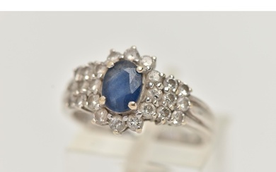 AN 18CT WHITE GOLD SAPPHIRE AND DIAMOND CLUSTER RING, centra...