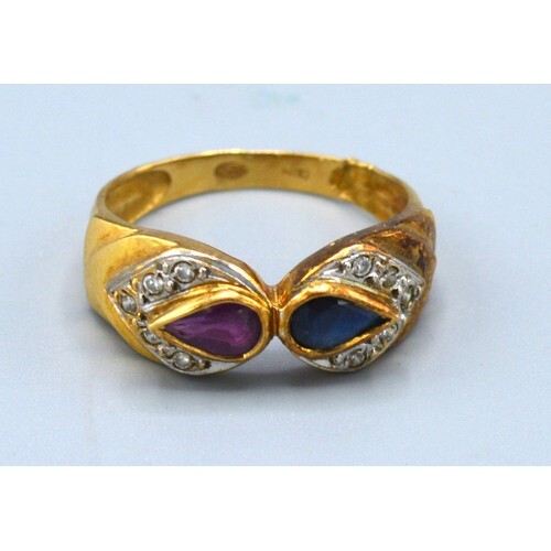 An 18ct. Gold Ring set teardrop sapphire and ruby surrounded...