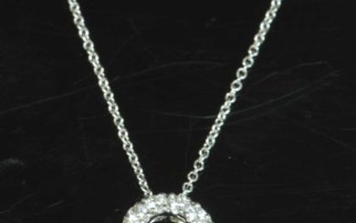 An 18ct white gold diamond set open quatrefoil slide pendant