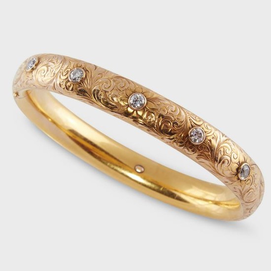 An Art Nouveau diamond and fourteen karat gold bangle