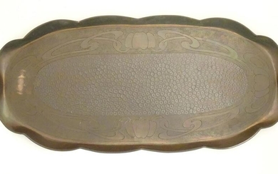 An Arts an Crafts oval copper tray with a scalloped rim