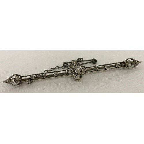 An Edwardian diamond set bar brooch with safety chain. Tests...