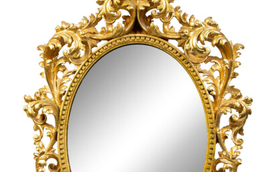 An Italian Rococo Style Carved Giltwood Oval Mirror and a Pair of Wall Brackets