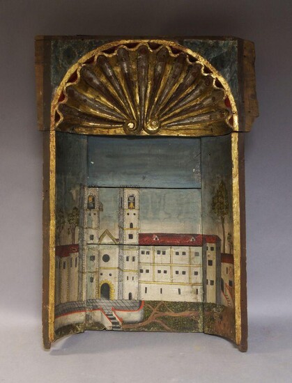 An Italian gilded and painted carved wood niche, 19th century, the Romanesque arched scroll with green marble effect spandrels and gilt shell pediment, decorated with an Italian monastery to a naturalistic backdrop, 118.5cm high overall