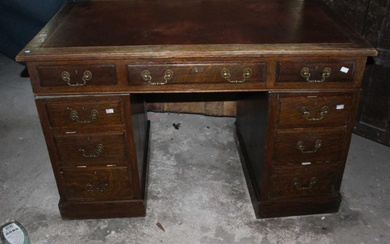 An antique twin pedestal oak desk with red leather top...