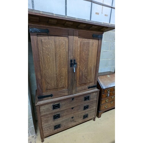 An early 20th century Arts & Crafts iron mounted oak linen p...