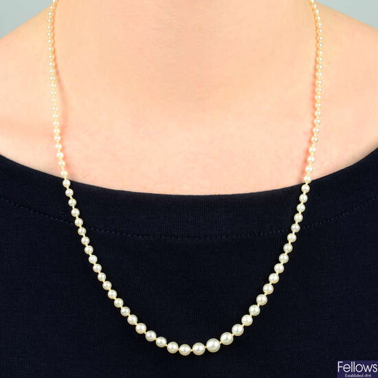 An early 20th century graduated pearl single-strand necklace, with sapphire cabochon and single-cut diamond cluster clasp.