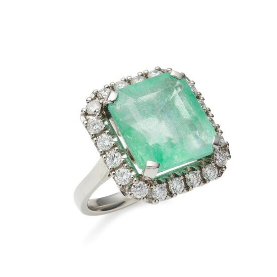 An emerald and diamond set cluster ring