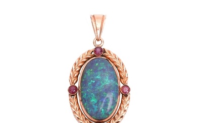 An opal and ruby pendant, featuring a large oval cabochon of...