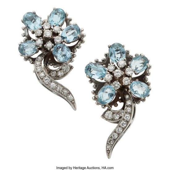Aquamarine, Topaz, Diamond, White Gold Earrings The earrings feature...
