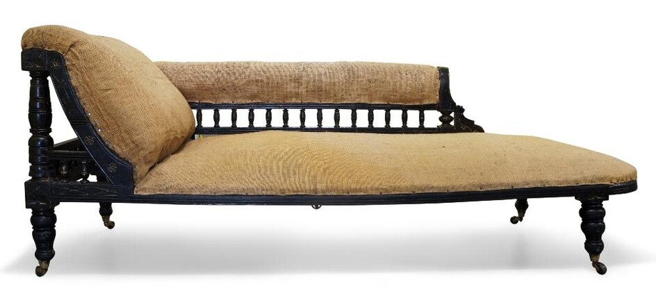 Designer Unknown, Aesthetic Movement chaise longue, circa 1870, Ebonised and parcel gilt wood, hessian fabric, brass caps, ceramic castors, 74cm high, 184cm wide, 65cm deep