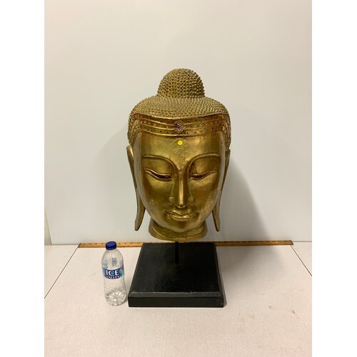 Extremely large carved wooden gilded Thai Buddha head on woo...
