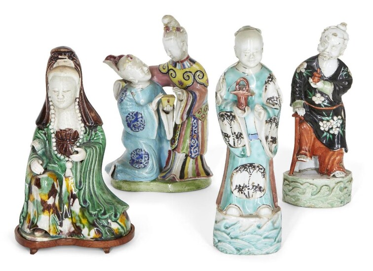 Four Chinese porcelain figures, 18th century, modelled as Guanyin, Li Tieguai, an attendant and a figure group of a couple, all painted with polychrome enamels, 18.5cm - 23cm high (4) Provenance: Private French collection; Three of the figures...