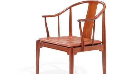 Hans J. Wegner: “China-Chair”. A mahogany armchair, loose cushion with cognac-coloured leather. Manufactured by Fritz Hansen in 1985.
