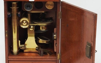 Microscope with accessories in its natural wooden case