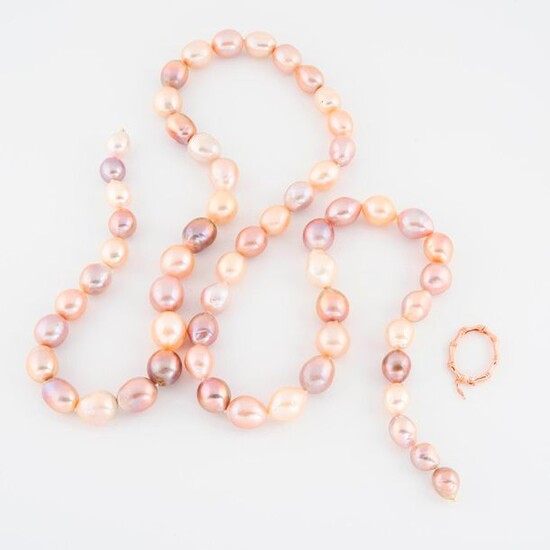 Necklace of baroque pearls of cultured pink colors, falling.