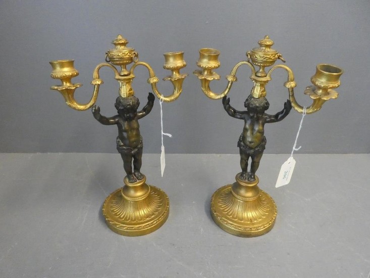 Pair of Rococo style candlesticks with gilded base surmounte...