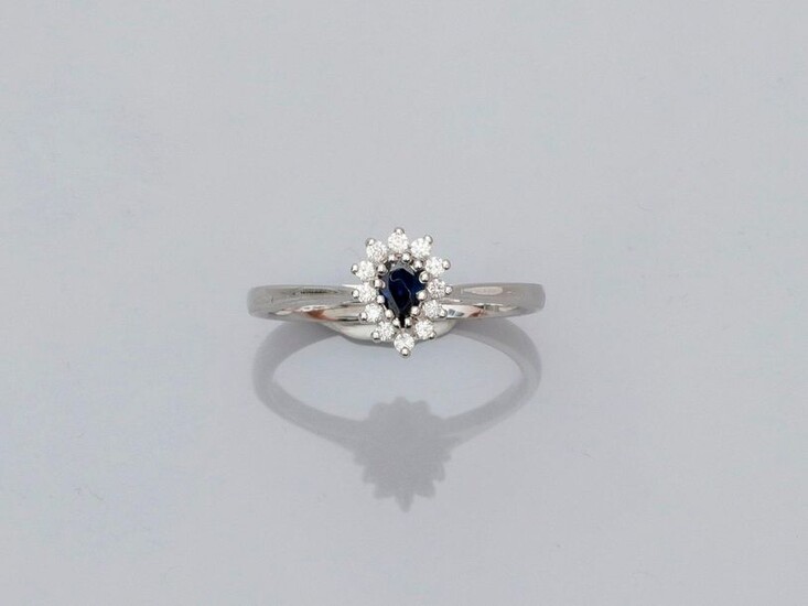 Small white gold ring, 750 MM, centered on a pear-cut sapphire surrounded by diamonds, size: 54, weight: 3.4gr. rough.