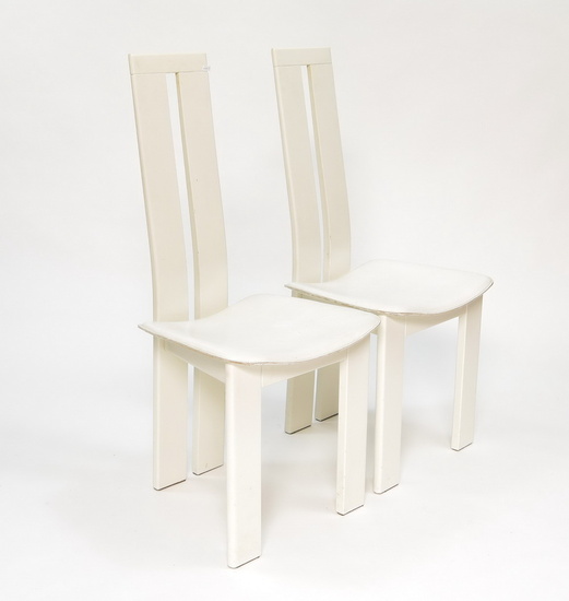 Two dining-room chairs with wooden back and white leather upholstery,...