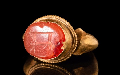 WESTERN ASIATIC GOLD FINGER RING WITH AN INTAGLIO DEPICTING AN...
