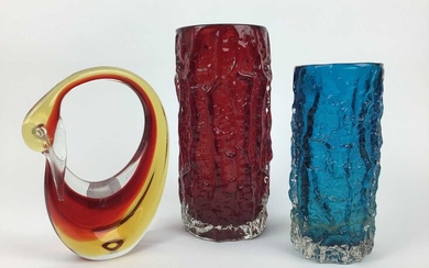 Whitefriars ruby red bark vase designed by Geoffrey Baxter, 23cm high, another kingfisher blue bark vase (af) and a coloured glass swan