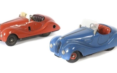 2 racing cars Schuco, 1 x Examico 4001, red, clockwork drive, stop lever, gear shift, orange tinted windscreen, ref: ''made in Germany'',l: 15 cm; 1 x Akustiko 2002, blue, clockwork drive each for engine and acoustics (horn)stop lever, horn, ''made in...
