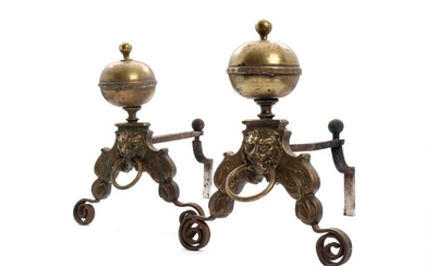 A pair of 18th century brass and iron andirons with lion heads and ring handles. H. 45. L. 59 cm. (2)