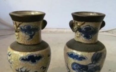 A pair of 19th Century Japanese blue and white vases and another lidded vase decorated figures with table of food (slightly...