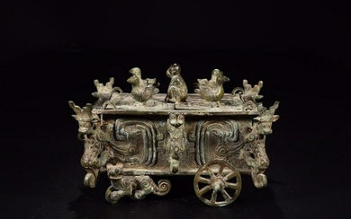 A COPPER ORNAMENT WITH CAR SHAPE