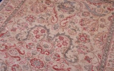 A Ziegler carpet with tasselled fringes the decoration of stylised Art Nouveau flora within a repeating border, on a cream...